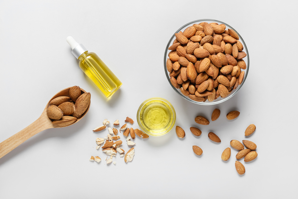 Composition with almond oil on light background