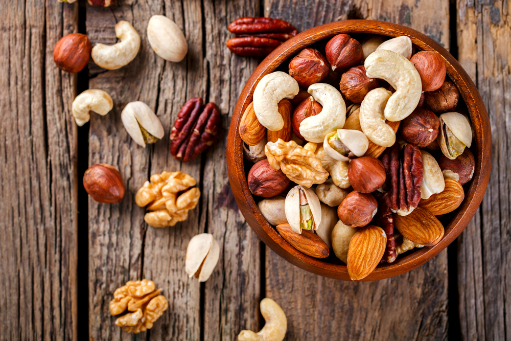 Nuts mixed in a wooden plate choices for charcuterie board